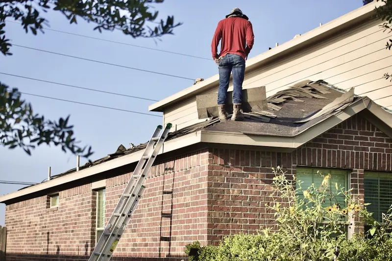 Professional roofer working on a residential roof in Rushsylvania